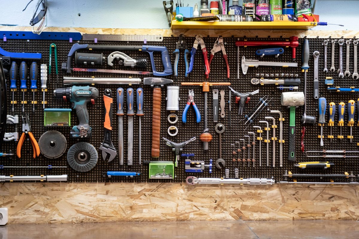 Hand tools and meters organized on a workshop pegboard