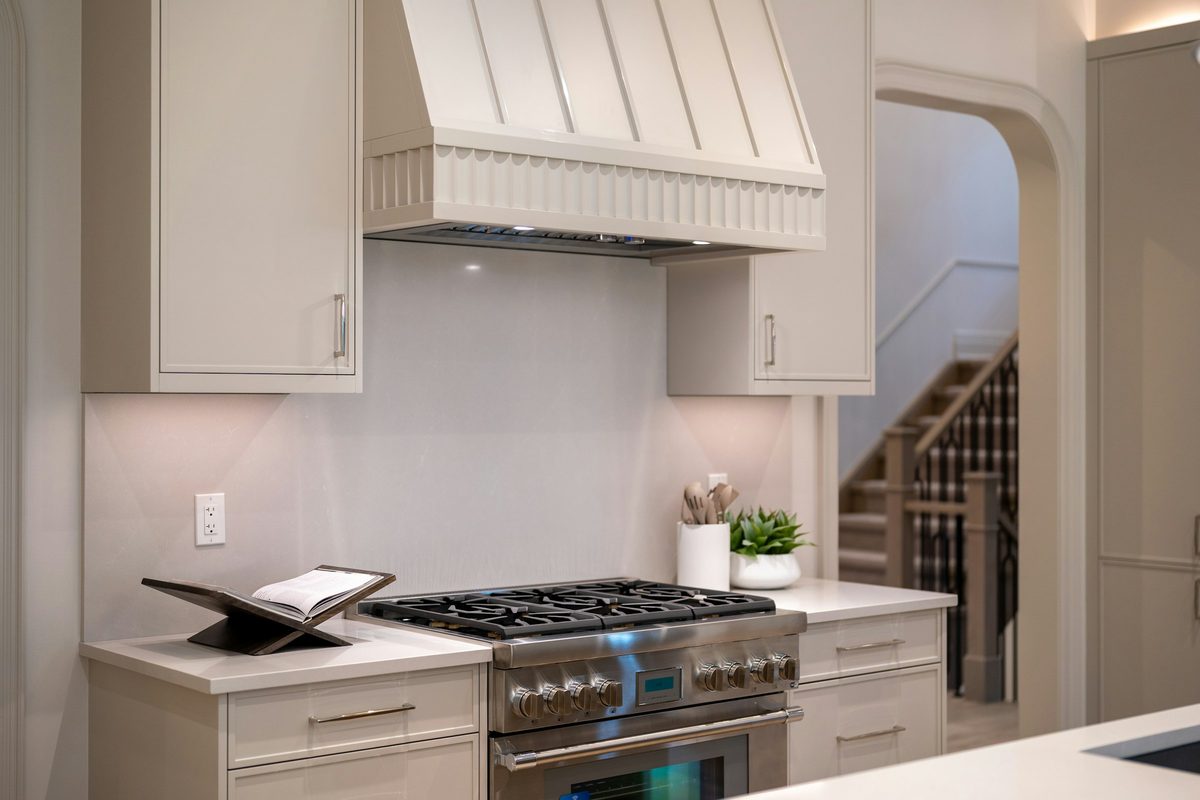 Stainless pro-style range under a custom range hood